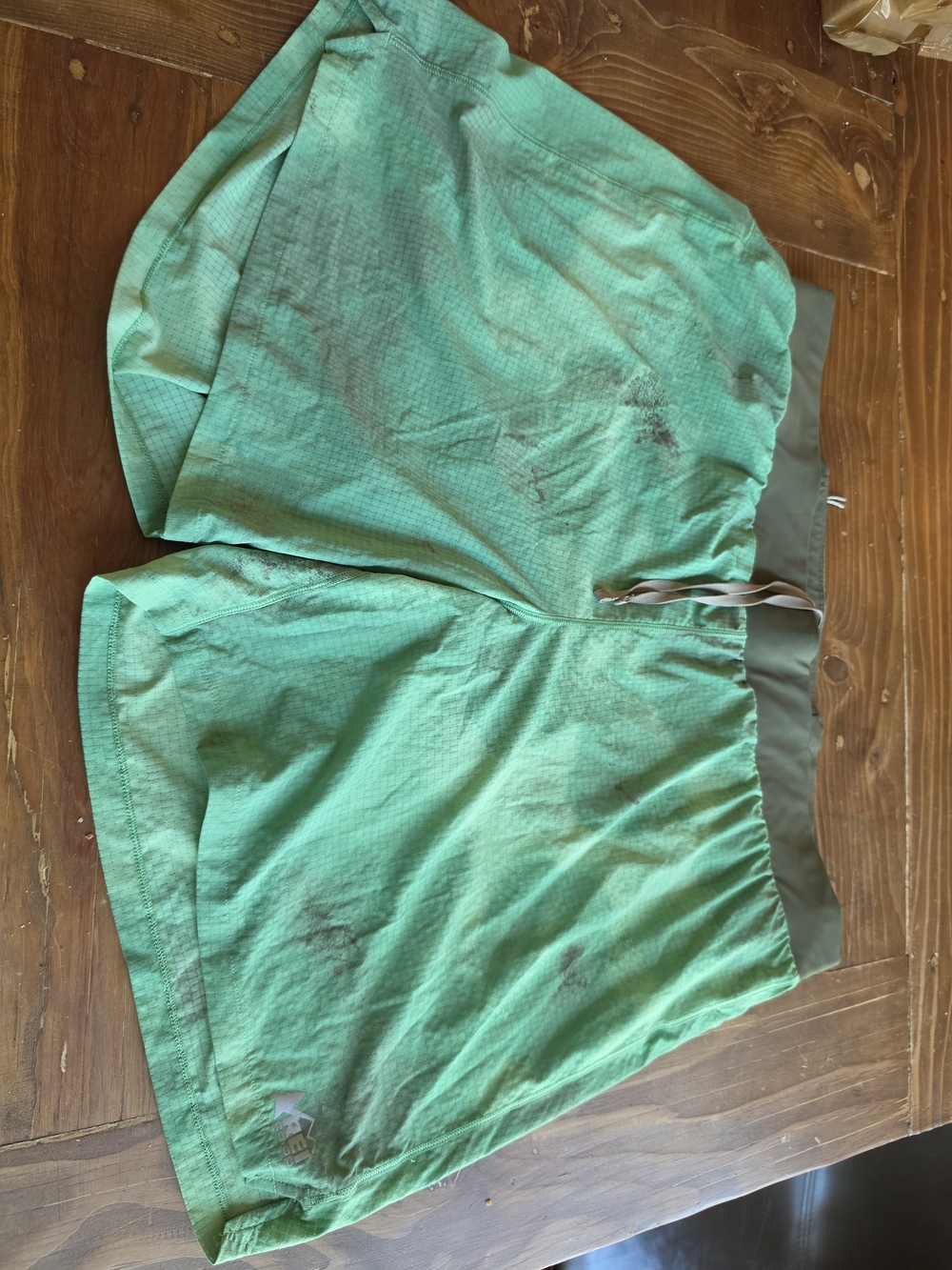 REI olive green and black hiking shorts